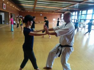 Richard Segissement kyoshi practicing partner walking exercise with seminar participant.