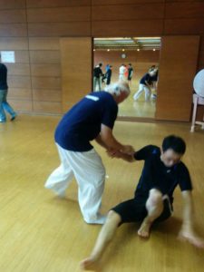 Hatta-san and a seminar participant practicing breaking balance (kuzushi).