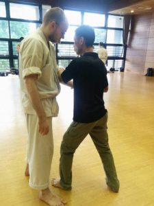 Glen Braun and a seminar participant practicing breaking balance (kuzushi).